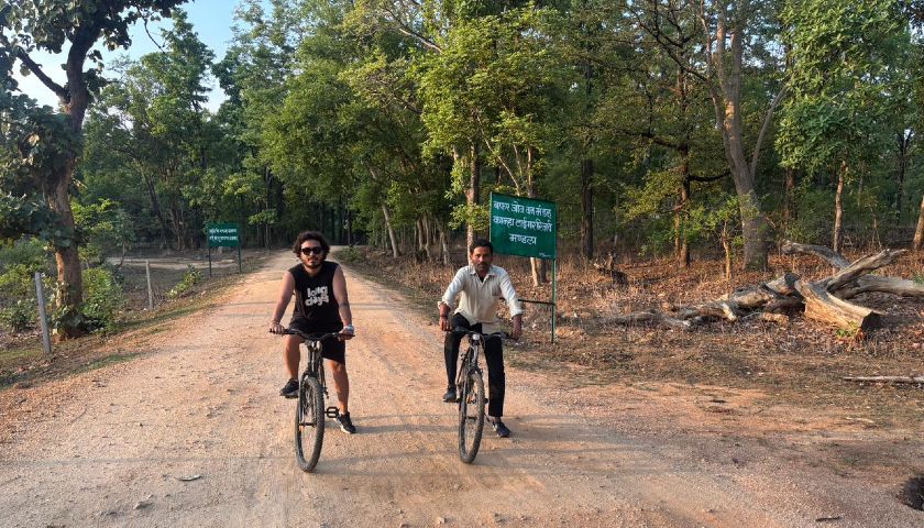 Avinash from Alkof Holidays cycling with local villagers in Kanha National Park