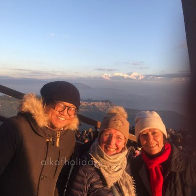 Traveler enjoying panoramic Himalayan views during a journey through Northeast India